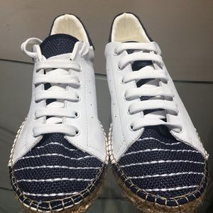 Andrew Stevens with navy raffia toe sneaker